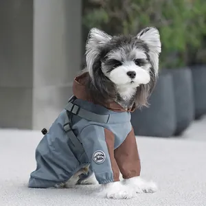 Waterproof dog raincoat in grey-blue with integrated harness and outdoor emblem