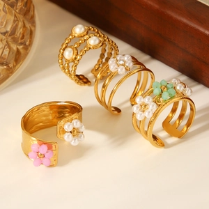 Detailed view of adjustable gold flower rings with pearls and colorful beads set