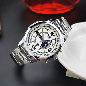 Macro shot of silver quartz watch with white dial, blue hands and tachymeter bezel detail