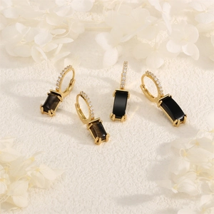 Detail showing 18K gold plated hoop earrings with zircon and black rectangular gemstone
