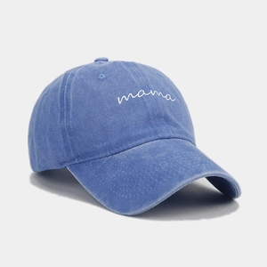 Detail of mama embroidery on a vintage washed blue denim baseball cap for women