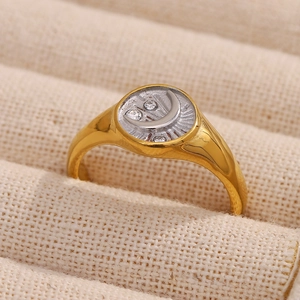 18K gold plated stainless steel moon signet ring with cubic zirconia on a linen cushion