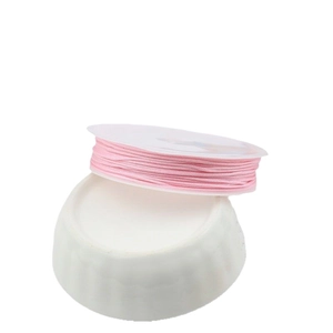 Pink handmade jewelry cord roll for DIY braiding and bracelets on white stand