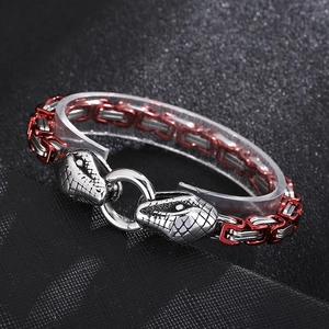 Detail of hip-hop snake head stainless steel bracelet with red and silver weave