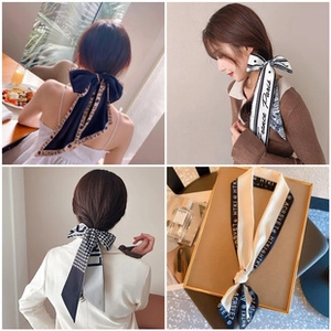 Detail showing various silk print hair scarves worn with elegant knots on hair