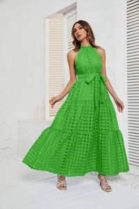 Detail of emerald green halter neck maxi dress with tiered skirt and grid texture
