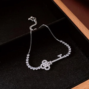 Adjustable silver key bracelet with cubic zirconia on black velvet jewelry box