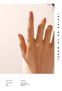 Detail of 18K gold plated snake-shaped open ring featuring textured scale patterns
