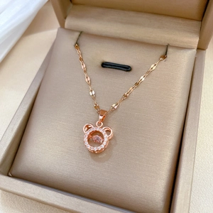 Rose gold dancing stone bear necklace with sparkling crystals in a luxury jewelry box