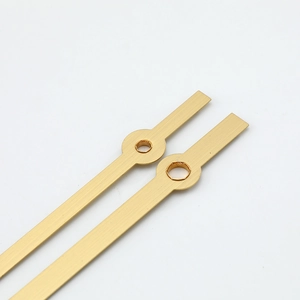 Minimalist golden quartz clock hands with brushed metal texture and circular mounting hole