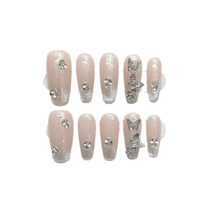 Glitter cat-eye nude press-on nails with silver butterfly and rhinestone accents