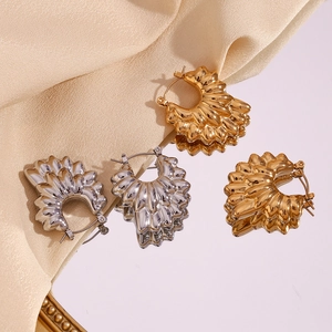 Detail shot of hollow layered petal earrings with gold and silver metallic texture