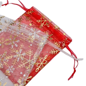 Translucent organza drawstring gift bags with gold snowflake foil print in red and white