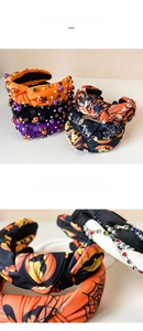 Detail of knotted Halloween headband with pumpkin prints and hand-sewn crystal beads