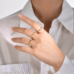Close-up of three gold stacked rings with micro-pave zircons on model's hand