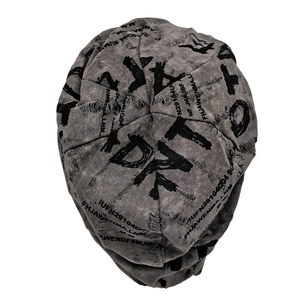 Detail of grey distressed beanie with ripped texture and black street style lettering