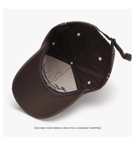 Detail view of brown cotton baseball cap showing interior lining, stitching and metal buckle