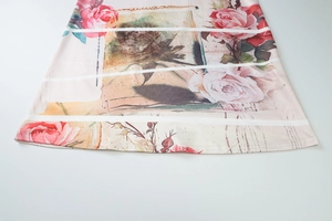 Detailed view of the vintage floral print and stripe patterns on light dress fabric