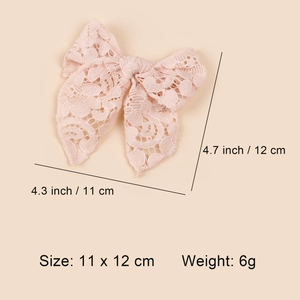 Pink lace hollow bow hair clip for girls with size dimensions 11 x 12 cm shown in top view