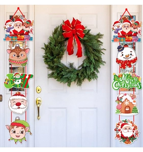 Detailed view of Christmas Santa and Snowman banners hanging on a white wooden door