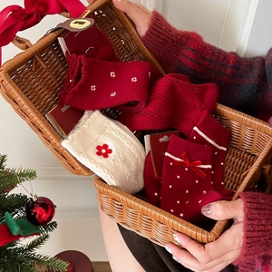 Christmas gift set of red and white thick thermal socks with bows in a basket