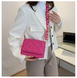 Pink crossbody bag with geometric quilted pattern and trendy patterned wide shoulder strap