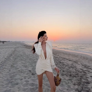 Elegant deep V-neck long sleeve mini dress in cream white with side ruching details