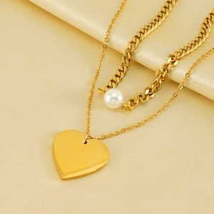 Vintage double layer necklace with gold heart pendant and pearl on champagne silk background