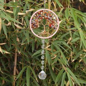 Macro detail of Tree of Life crystal pendant with colorful stones and clear prism ball