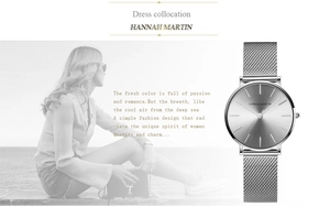 Detail showing the silver stainless steel mesh band and minimalist dial of the watch