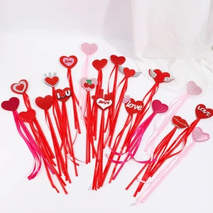 Glittery heart-shaped wands with tassels and love engraving for Valentine's Day party props