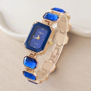 Elegant gold quartz watch with octagonal blue dial and gemstone-encrusted bracelet link
