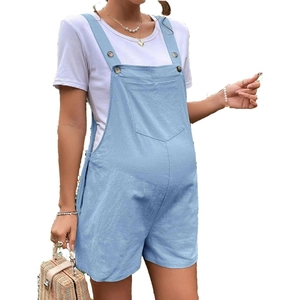 Detail of adjustable shoulder straps and chest pocket on blue maternity denim shorts