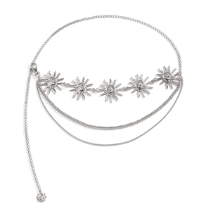 Detail of silver layered metal waist chain featuring vintage sun face charms and lobster clasp