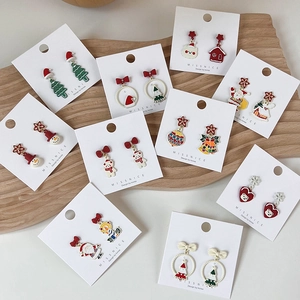 Detail view of colorful Christmas stud earrings set featuring Santa and reindeer motifs