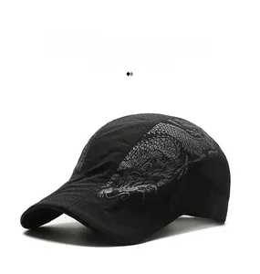 Detail of black breathable flat cap featuring grey dragon print and laser-cut vent holes