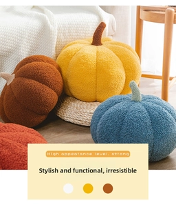 Plush pumpkin throw pillows in various colors like orange and yellow on a wooden floor