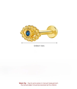 Macro shot of gold-plated copper lip stud with a blue gemstone inlay and size details
