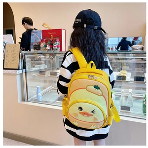 Detail of yellow cartoon duck toddler backpack showing dual zippers and mesh side pockets