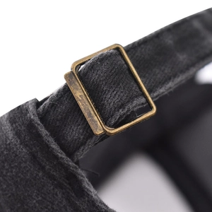 Detailed macro view of the vintage bronze buckle and cotton strap on the baseball cap