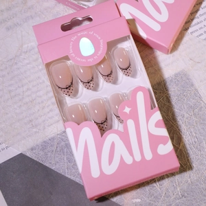 French almond press-on nails with black bow and polka dots in pink gift box