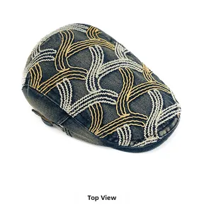 Top view of retro denim beret showing detailed yellow and white curved embroidery