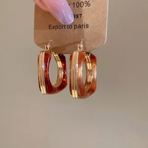 U-shaped 18k gold plated resin earrings with tortoise pattern on display card