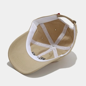 Inside view of khaki baseball cap featuring white reinforced stitching and metal buckle