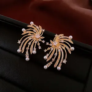 Elegant gold star pearl earrings with cubic zirconia in a fireworks spray design