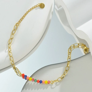 Detail of 14k gold-plated stainless steel chain with colorful beads and S.Steel tag
