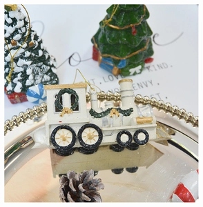 Macro detail of retro resin steam train ornament with golden accents for Christmas trees