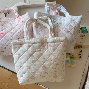 Detailed view of floral quilted cotton tote bags with simple wish labels
