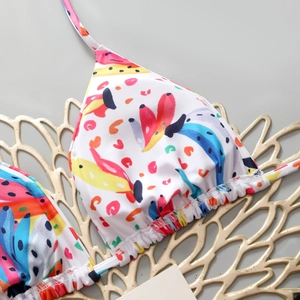 Detail of floral bikini top featuring triangle cups and vibrant tropical print