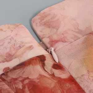 Detail of invisible zipper on floral chiffon top showing high-quality stitching